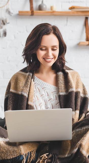 Convection Heating & Air - woman under covers, uses laptop